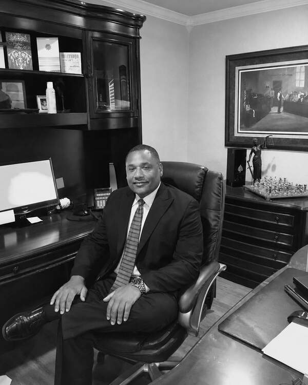 Mark A. Sampson seated in his Austin law office